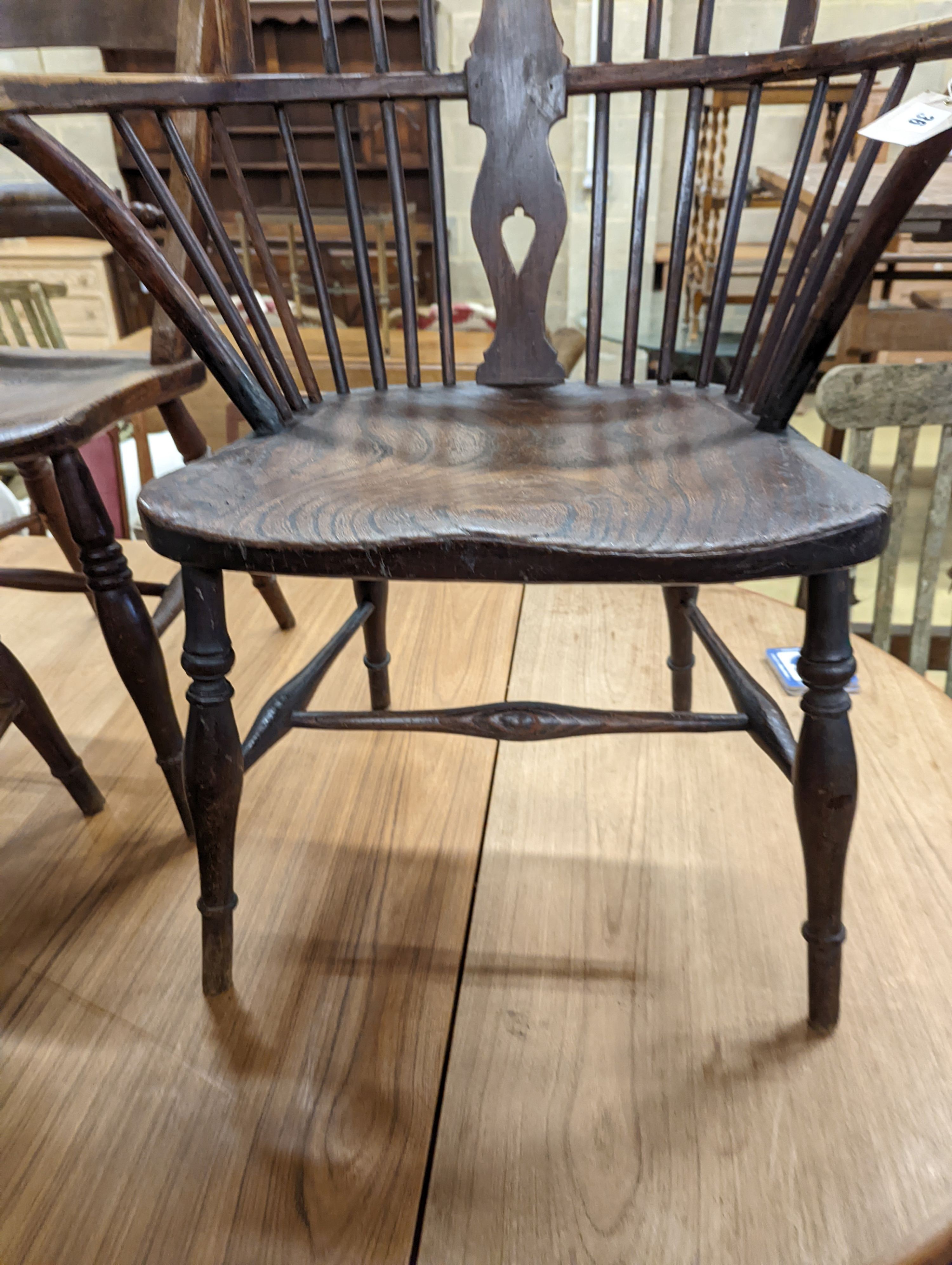 A mid 19th century Windsor ash and elm comb and wheelback armchair. H-104cm.